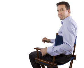 male casting director sitting on a folding chair