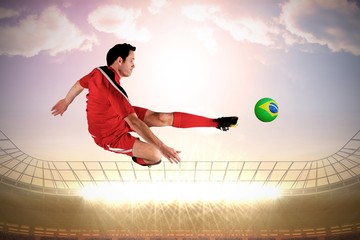 Fototapeta na wymiar Football player in red kicking