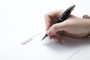 pen in the man's hand and signature