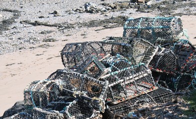 Fototapeta na wymiar Pile of lobster of creel pots on beach