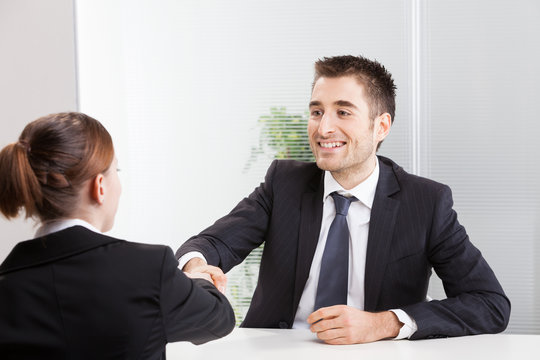 Business people having job interview with young woman.
