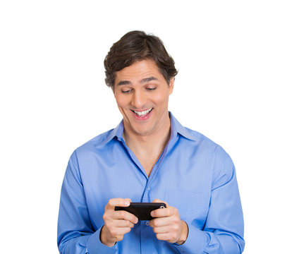 Happy man sees something exciting on phone, smiling