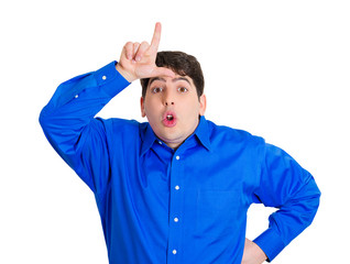Rude young man giving loser sign showing his disgust to someone