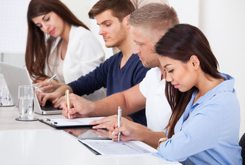 Businesspeople Working At Desk