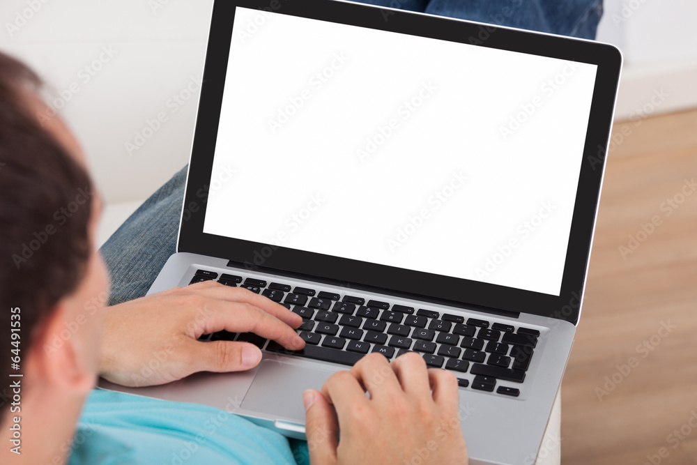 Poster man using laptop at home