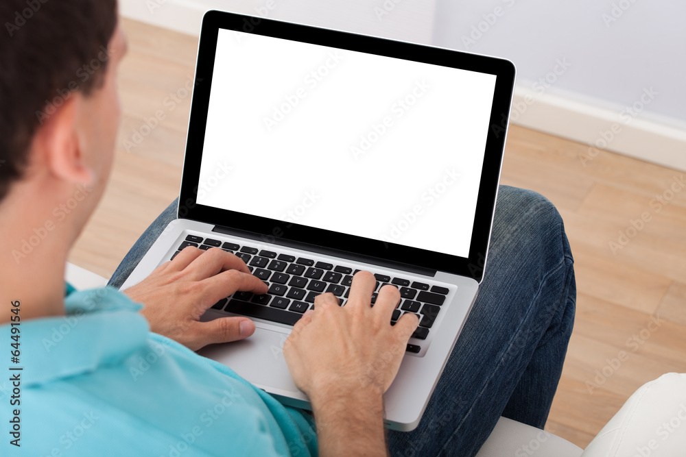 Poster man using laptop at home