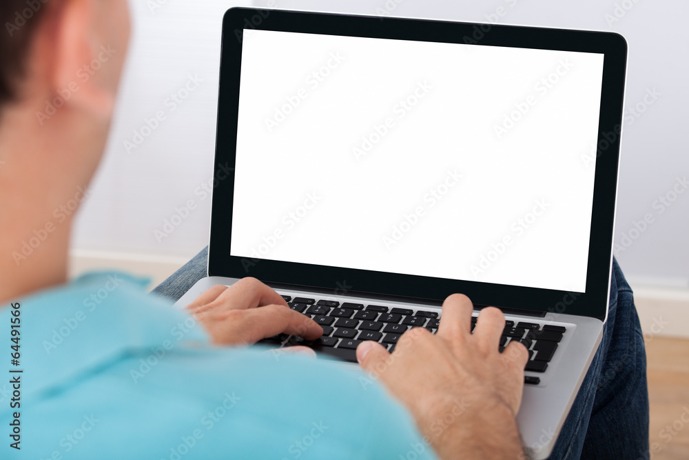 Poster man using laptop at home