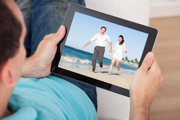 Man Watching Movie On Digital Tablet