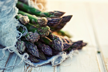 Bunch of fresh asparagus on wooden table