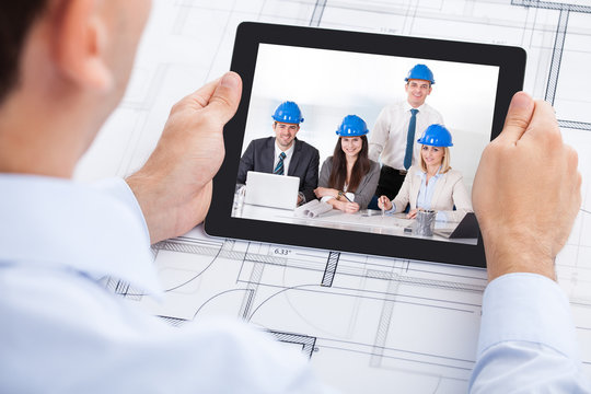 Architect Video Conferencing With Team Through Digital Tablet