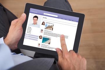 Businessman Surfing Social Networking Site On Digital Tablet