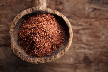 fine grated chocolate in old wooden spoon