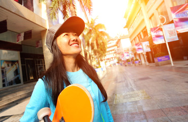 skateboarding woman take a skateboard at city street