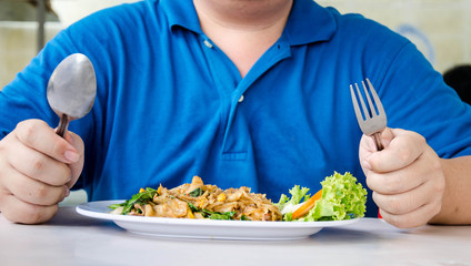 Men eating noodles close up