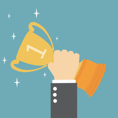 Hand holding a winner's trophy