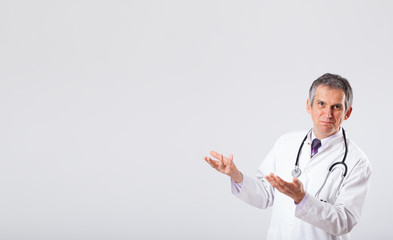 Doctor listening to empty copy space with stethoscope