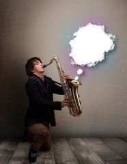 Young man playing on saxophone with copy space in white cloud