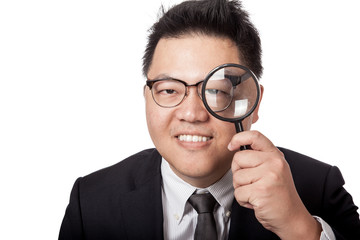 Fototapeta na wymiar Asian businessman look through magnifying glass