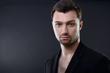 Portrait of handsome young man over black