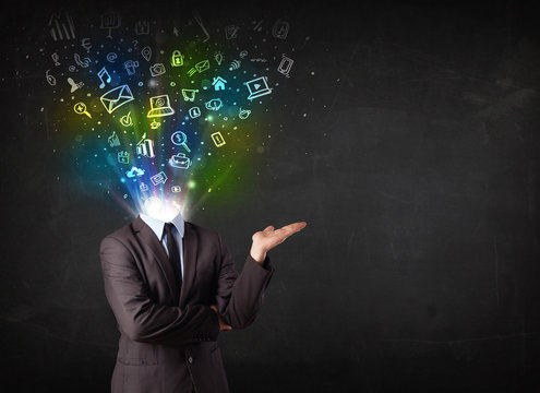Business man with glowing media icons exploding head