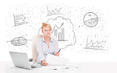 Business woman sitting at table with hand drawn graph charts