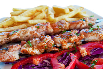 Meat grilled on skewers with chips