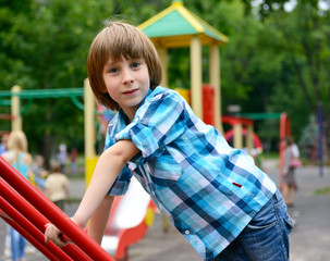 child playing on  playground in summer outdoor park