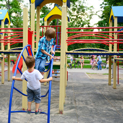children playing on  playground in summer outdoor park