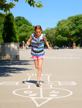 Hopscotch, Girl Jumps In Summer Park Outdoor