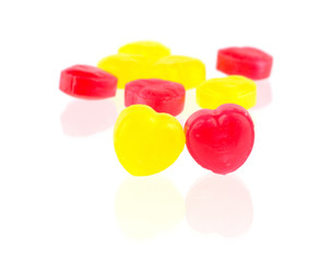 Red and yellow candy hearts isolated on white background