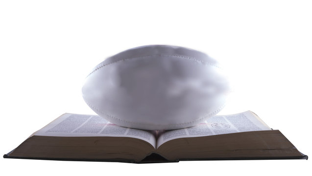 Rugby ball over book - Powered by Adobe