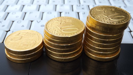 White Notebook Keyboard and Gold Coins