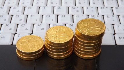 White Notebook Keyboard and Gold coins