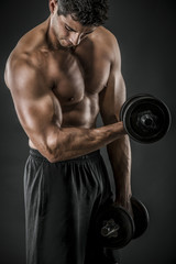Fototapeta na wymiar Muscular man lifting weights