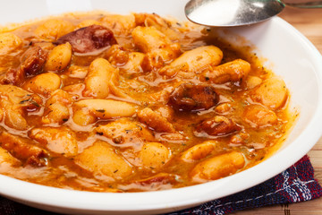Beans with tomato sauce, bacon and sausage