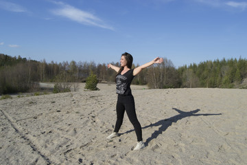 Woman stretching / working out at the beach (yoga)