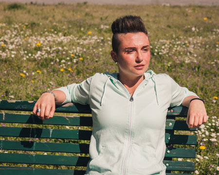 Portrait of a short hair girl sitting on bench