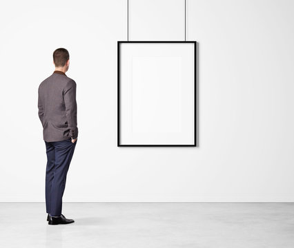 Man looking at white poster