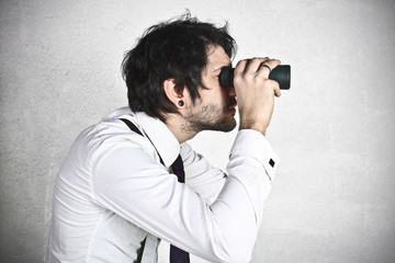 Young businessman spying