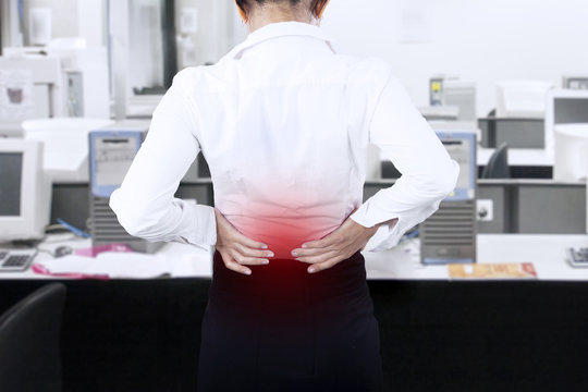 Businesswoman Having Back Pain At Office