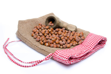 Hazelnuts and a nutcracker on a burlap bag