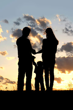 Family with Young Child Silhouette at Sunset