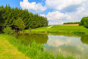Fototapeta na wymiar Lake in countryside landscape in spring, Austria
