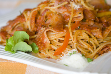 Spaghetti with bacon on the table.