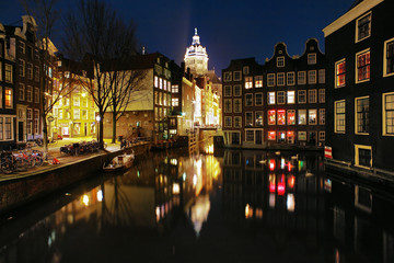 Evening view on the channels of Amsterdam and St. Nicolas Church