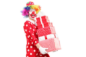 Male clown carrying a pile of gifts