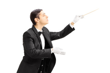 Male orchestra conductor directing with stick