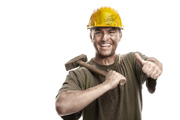 Young dirty smiling Worker Man With Hard Hat helmet  .holding a