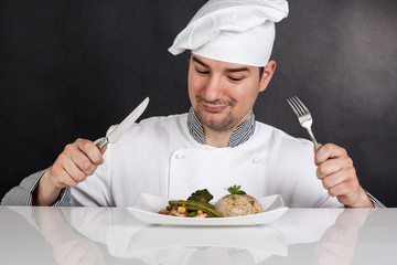 Chef eating his prepared food with cutlery