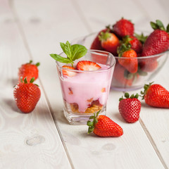 Strawberry yogurt and granola in glass